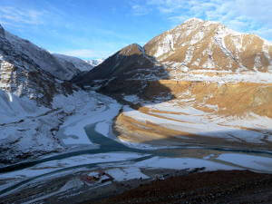 Confluence of Zanskar frozen river and Indus in winter